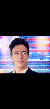 a man in a suit and tie is standing in front of a screen
